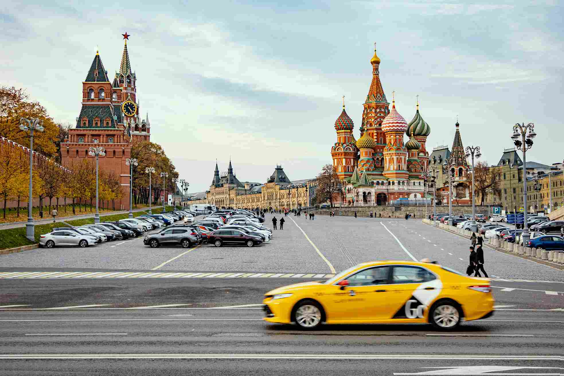 Yellow taxi Moscow Red Square St Basils Cathedral Kremlin tower Russia autumn