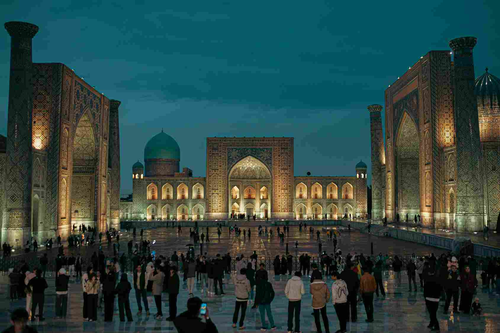 Registan Square illuminated night tourists Samarkand Uzbekistan
