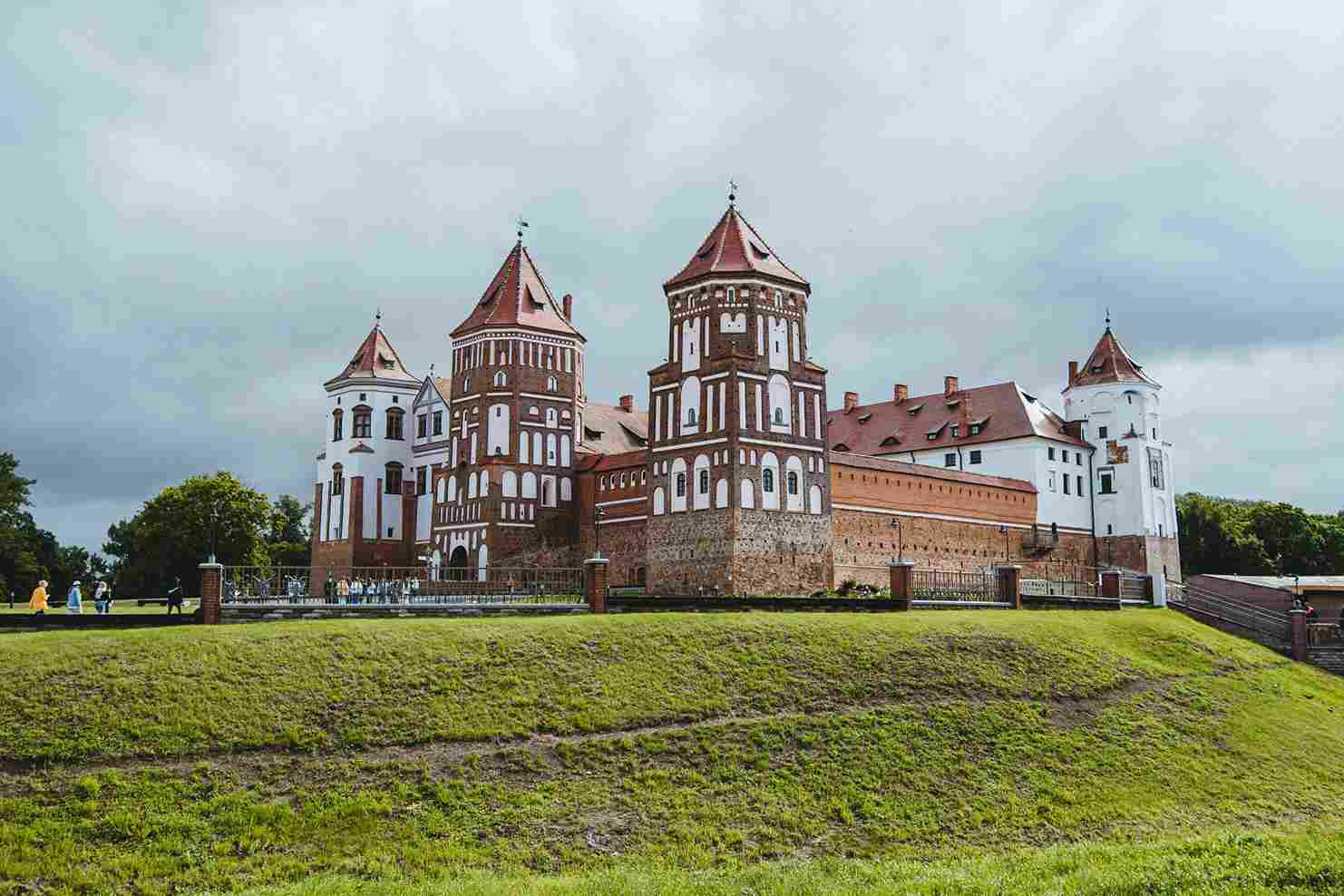 Mir Castle medieval red brick towers green lawn Belarus UNESCO landmark