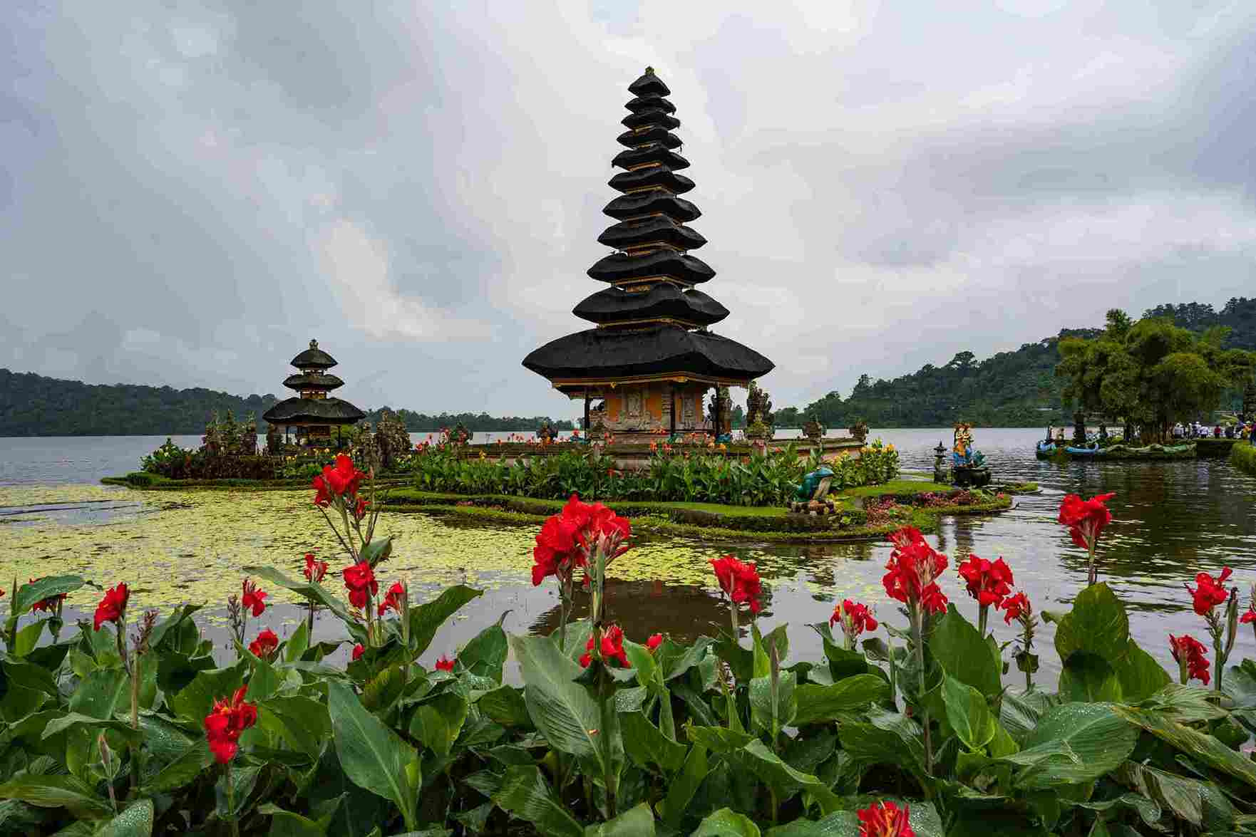 Ulun Danu Beratan water temple red flowers Lake Bratan Bali Indonesia